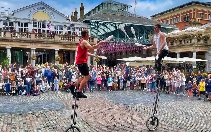 Performers juggle in Covent Garden