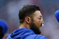 New York Mets' Kevin Pillar stands for the national anthem before the team's baseball game against the Atlanta Braves on Tuesday, May 18, 2021, in Atlanta. Pillar was hit on the face with a Jacob Webb fastball the night before. (AP Photo/John Bazemore)