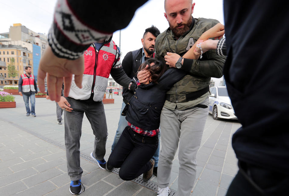 Police officers detain protester