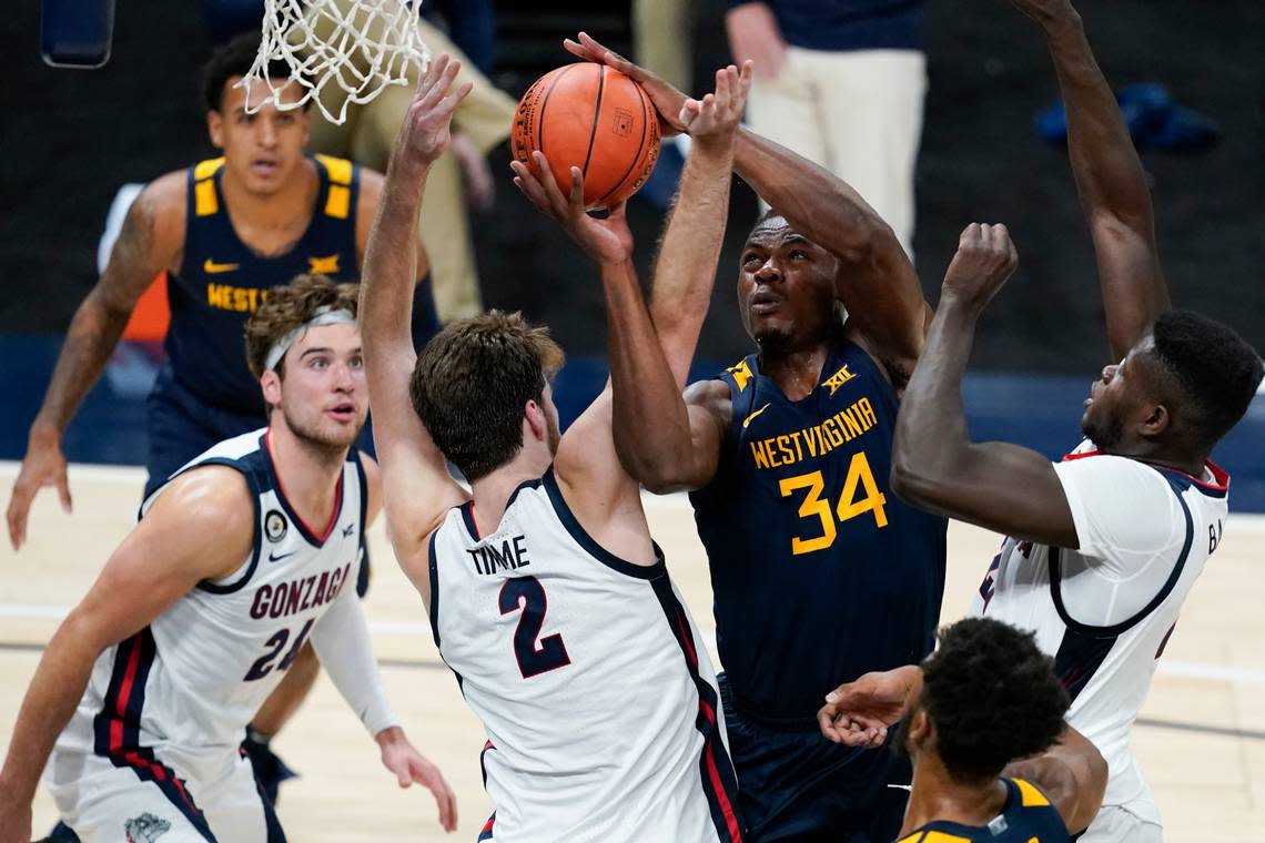 West Virginia’s Oscar Tshiebwe (34) is fouled by Gonzaga’s Drew Timme (2) during the first half of an NCAA college basketball game on Dec. 2, 2020, in Indianapolis.