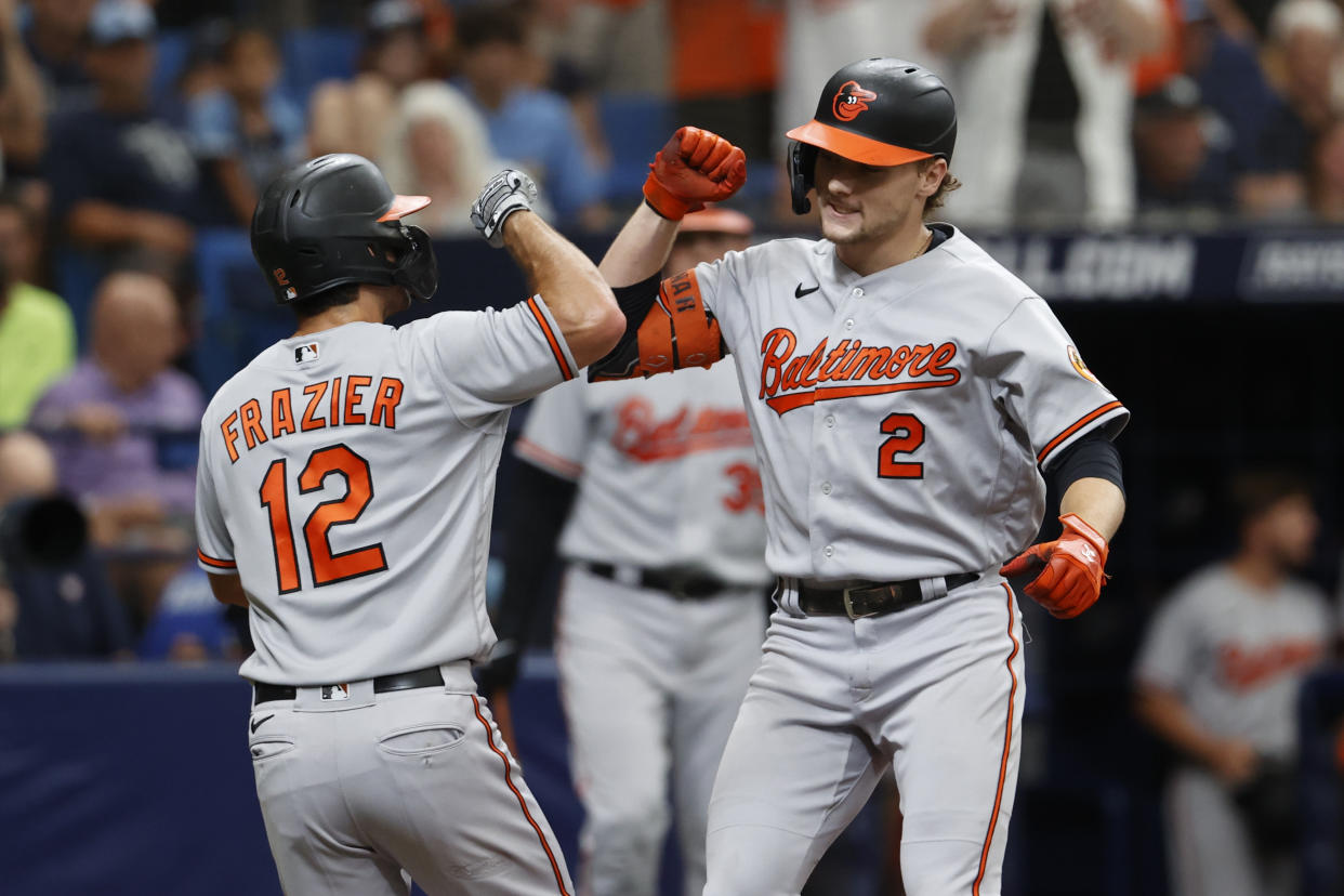 Baltimore Orioles' Gunnar Henderson, right, celebrates with teammate Adam Frazier after hitting a two-run home run against the Tampa Bay Rays. (AP Photo/Scott Audette)
