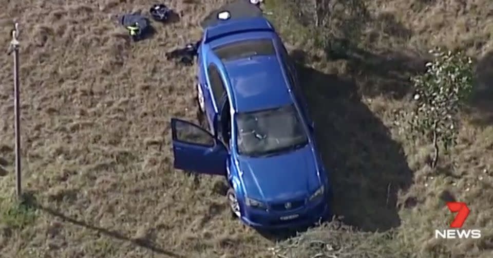 This blue Commodore was found in parkland nearby. Source: 7 News