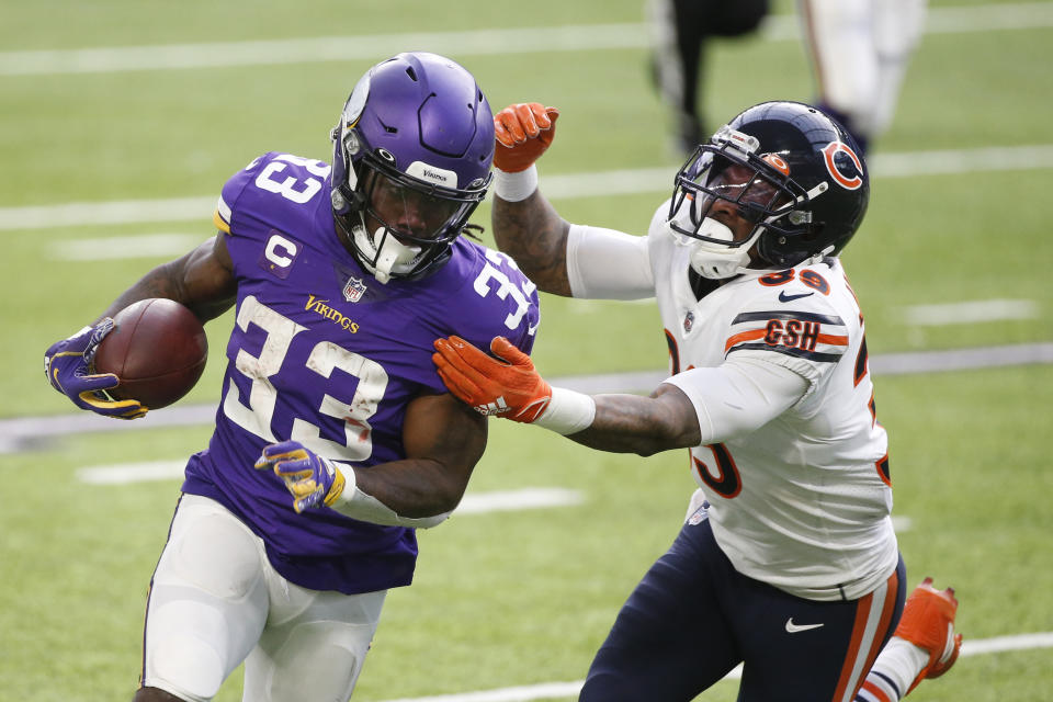 Minnesota Vikings running back Dalvin Cook (33) runs from Chicago Bears safety Eddie Jackson (39) during the first half of an NFL football game, Sunday, Dec. 20, 2020, in Minneapolis. (AP Photo/Bruce Kluckhohn)
