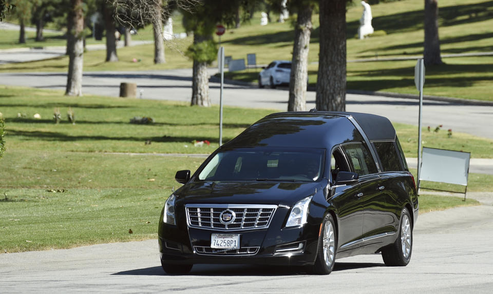 A hearse leaves a burial service for the late rapper Nipsey Hussle at Forest Lawn Hollywood Hills cemetery, Friday, April 12, 2019, in Los Angeles. (Photo by Chris Pizzello/Invision/AP)