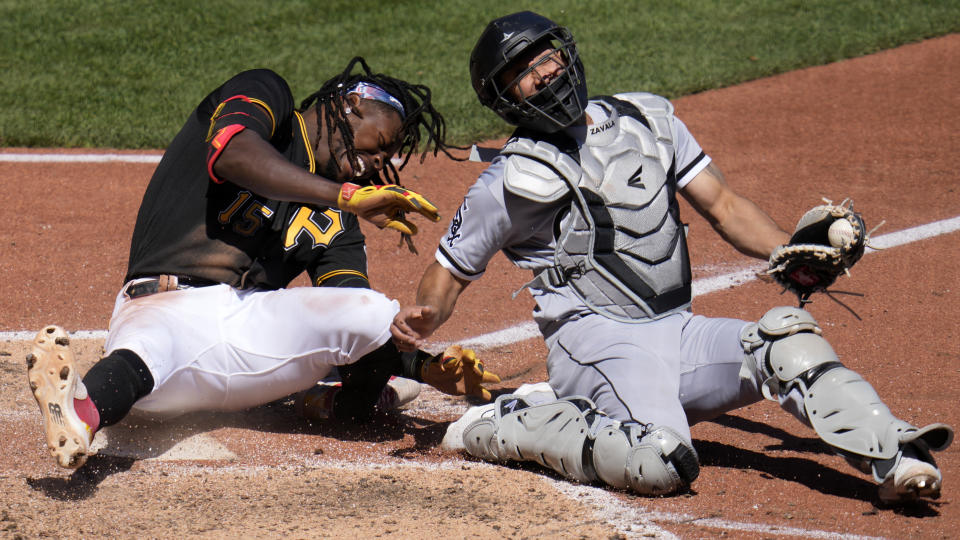 Pittsburgh Pirates' Oneil Cruz (15) is injured as he is tagged out attempting to score by Chicago White Sox catcher Seby Zavala during the sixth inning of a baseball game in Pittsburgh, Sunday, April 9, 2023. A bench clearing brawl ensued as a result of the play. The Pirates won 1-0. (AP Photo/Gene J. Puskar)