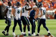 FILE PHOTO: Sep 9, 2018; Denver, CO, USA; Seattle Seahawks head coach Pete Carroll reacts with tight end Will Dissly (88) and defensive tackle Quinton Jefferson (99) and tight end Nick Vannett (81) and defensive end Dion Jordan (95) in the first quarter against the Denver Broncos at Broncos Stadium at Mile High. Mandatory Credit: Isaiah J. Downing-USA TODAY Sports/File Photo