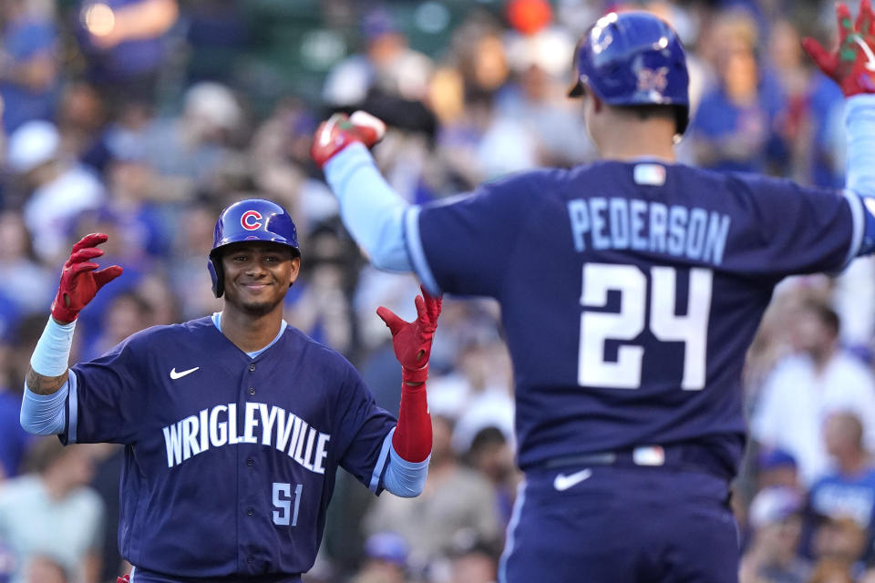 Chicago Cubs' Sergio Alcantara, left, celebrates with Joc Pederson after hitting a solo home run during the third inning of the team's baseball game against the St. Louis Cardinals in Chicago, Saturday, June 12, 2021. (AP Photo/Nam Y. Huh)