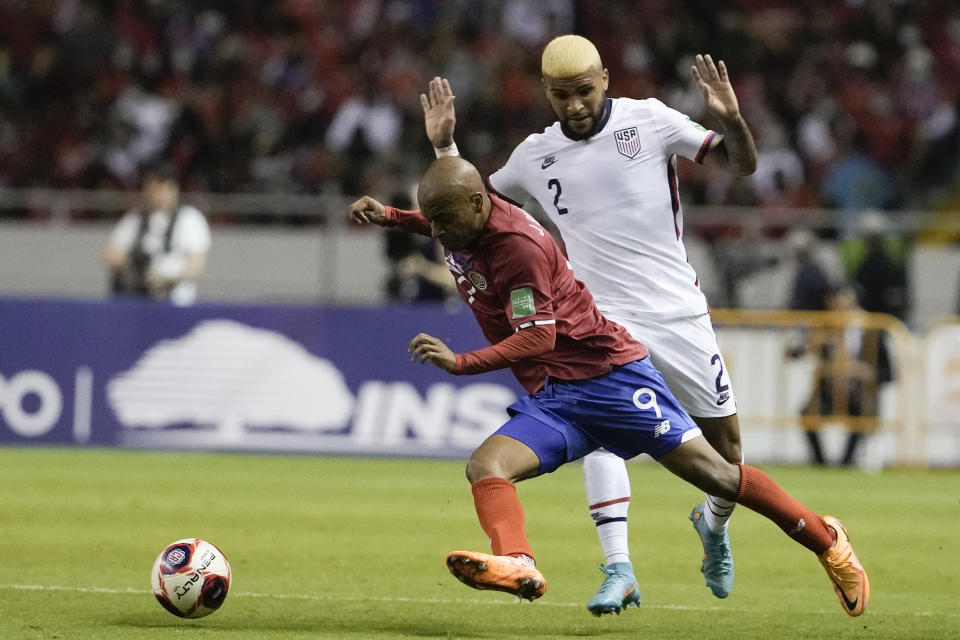 United States' Deandre Yedlin, right, and Costa Rica's Jewison Bennette battle for the ball during a qualifying soccer match for the FIFA World Cup Qatar 2022 in San Jose, Costa Rica, Wednesday, March 30, 2022. (AP Photo/Moises Castillo)