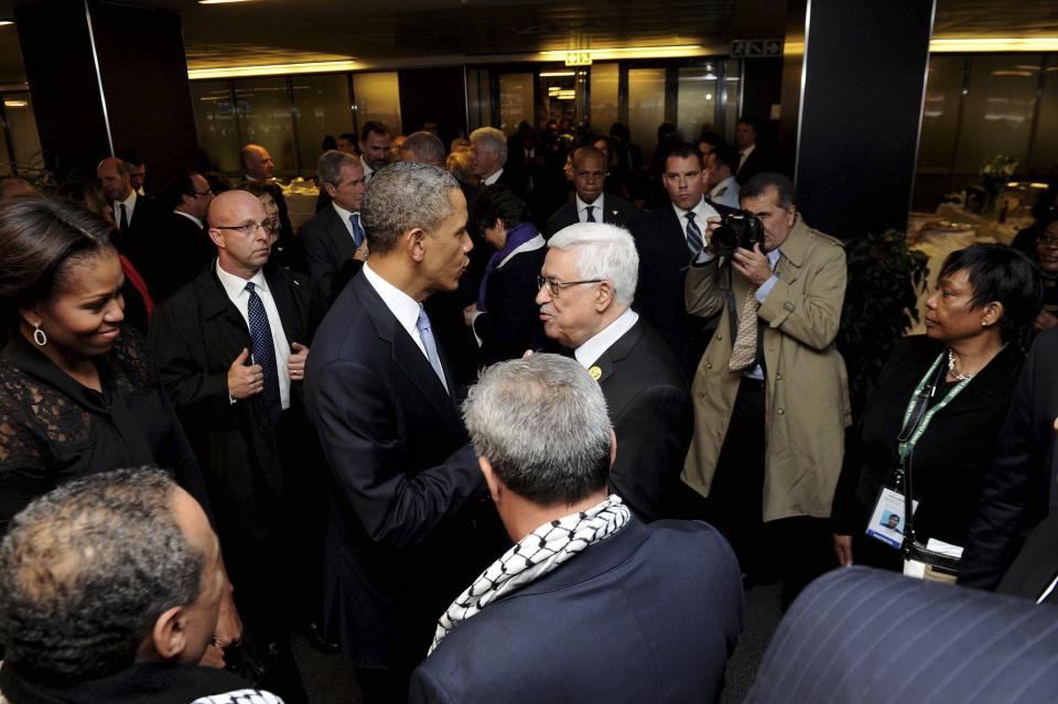 GCIS handout photo shows U.S. President Obama talking with Palestinian President Abbas at the Memorial Service for Mandela in Johannesburg