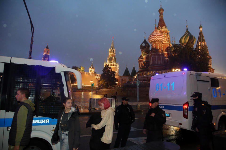 Police officers detain protesters in Moscow