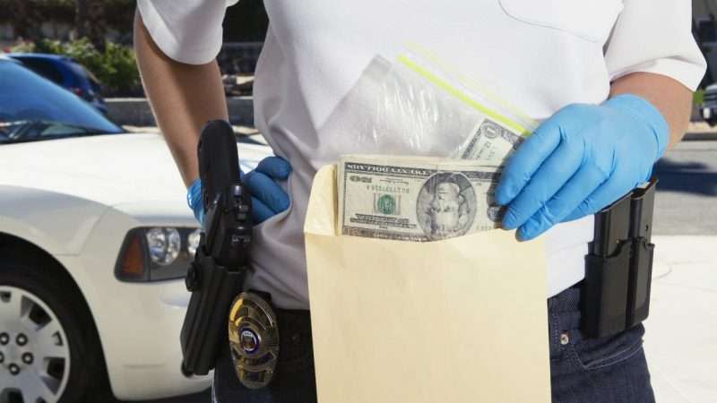 cop holding money