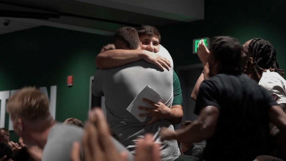 PHOTO: Zack Conti and Brian Dooley, Eastern Michigan University football players, embrace after Dooley gave Conti his football scholarship. (EMU Athletics)
