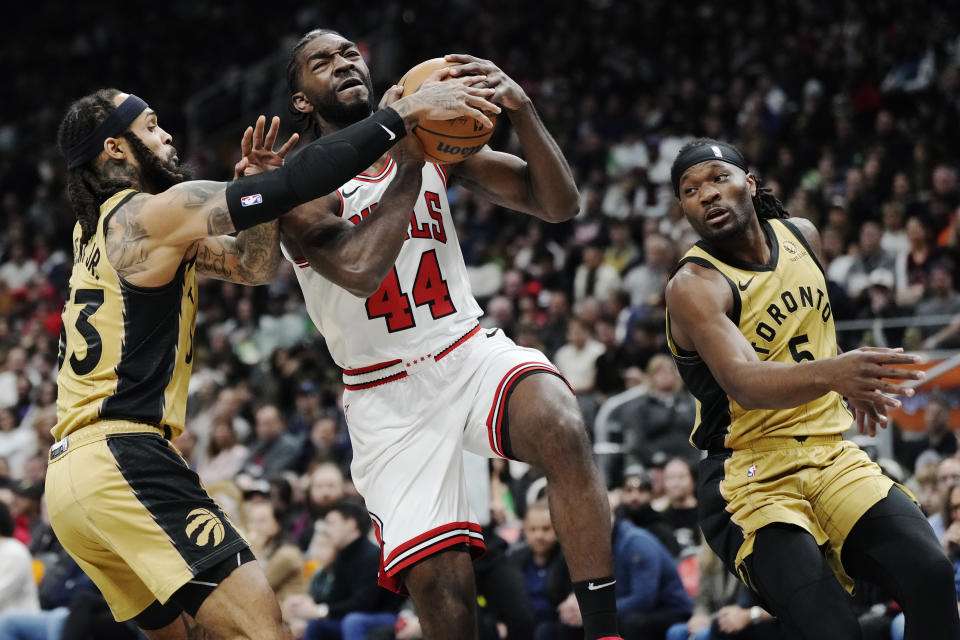 Chicago Bulls' Patrick Williams (44) is fouled by Toronto Raptors' Gary Trent Jr. (33) as Precious Achiuwa (5) watches during the first half of an NBA basketball In-Season Tournament game Friday, Nov. 24, 2023, in Toronto. (Frank Gunn/The Canadian Press via AP)