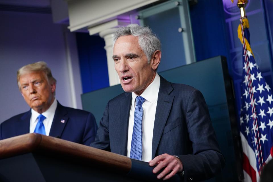 President Donald Trump (L) listens to White House coronavirus adviser Dr. Scott Atlas speak during a press conference in the Brady Briefing Room of the White House on September 23, 2020, in Washington, DC. (Mandel Ngan/AFP via Getty Images)