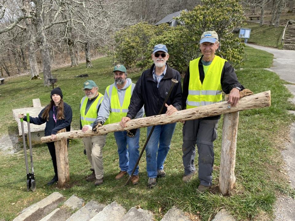 Restoration workers pose behind a newly-added handrail at the Craggy picnic area, which is on the Blue Ridge Parkway at milepost 364.4 – 367.6.