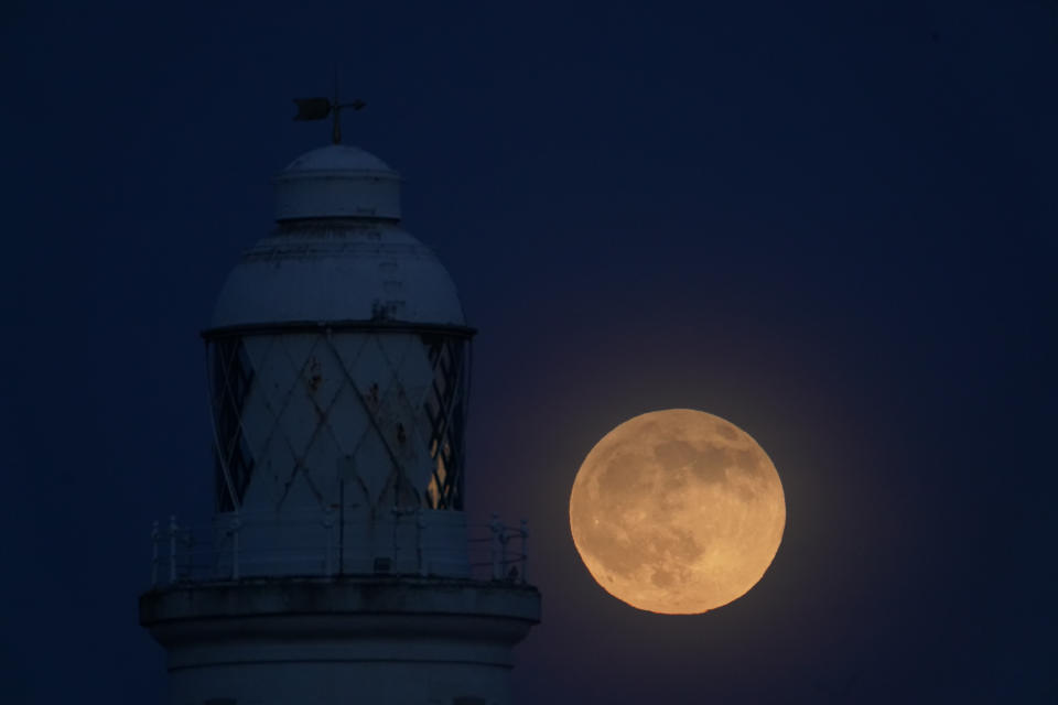 A view of the "wolf moon",the first full moon of 2020, over St Mary's Lighthouse at Whitley Bay in Northumberland, on the night that it coincides with a penumbral lunar eclipse.