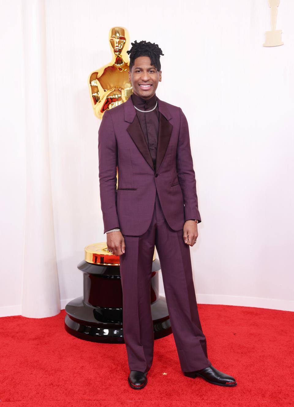 Image may contain: Jon Batiste, Person, Standing, Clothing, Formal Wear, Suit, Adult, Fashion, Footwear, Shoe, and Coat