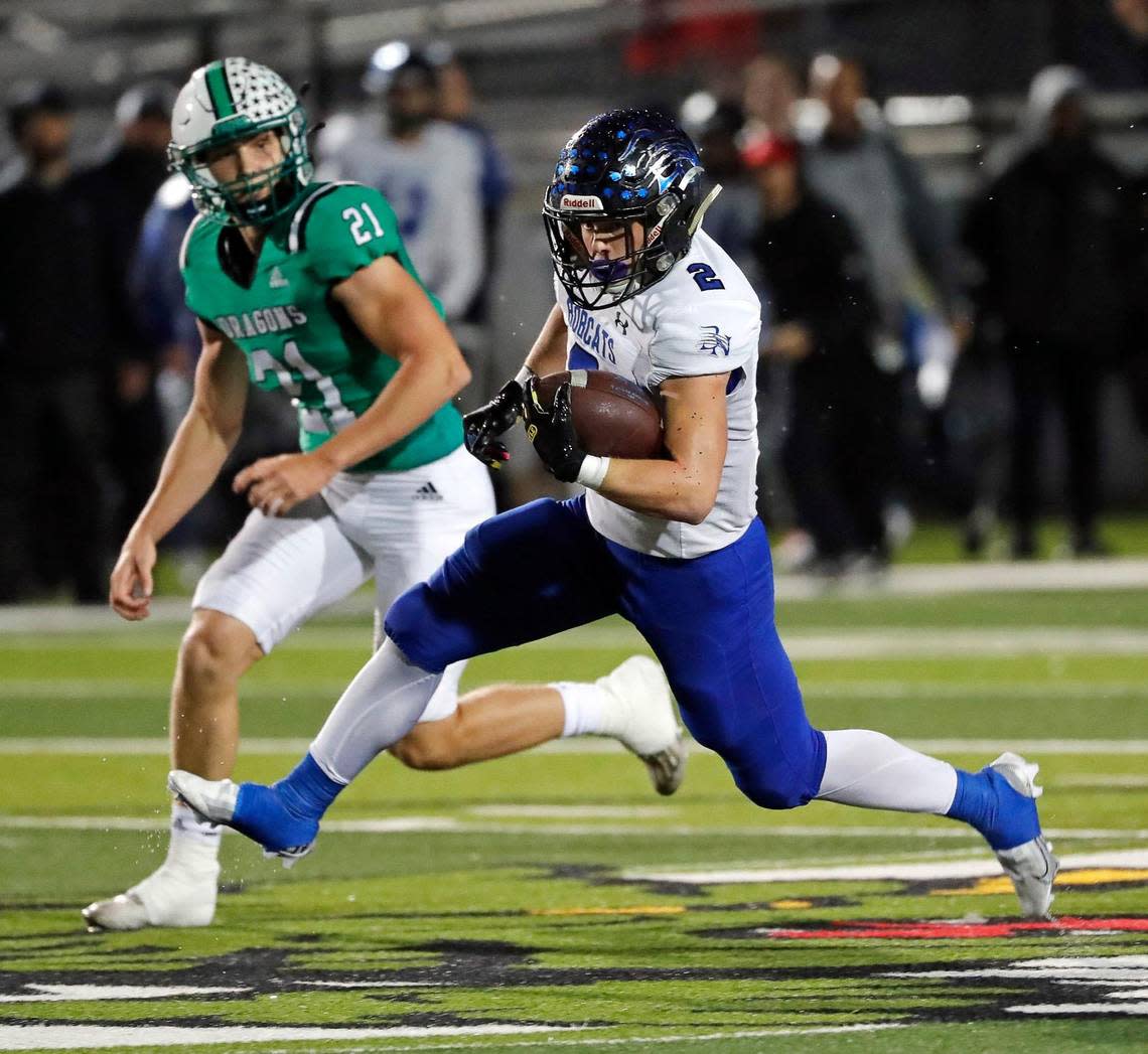 Byron Nelson’s Aaron Darden (2) outruns the defense of Southlake Carroll defensive back Connor Hill (21) in the first half of a District 4-6A football game at Dragon Stadium in Southlake, Texas, Friday, Oct. 28, 2022. Carroll led Byron Nelson 21-13 at the half. (Special to the Star-Telegram Bob Booth)