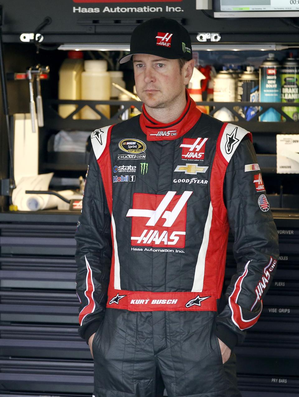 Kurt Busch stands by himself in the garage during NASCAR Sprint Cup auto racing practice Saturday, March 1, 2014, in Avondale, Ariz. (AP Photo/Ross D. Franklin)