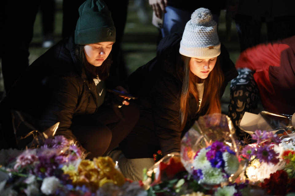 Mourners attend a vigil at The Rock on the grounds of Michigan State University in East Lansing, Mich., Wednesday, Feb. 15, 2023. Alexandria Verner, Brian Fraser and Arielle Anderson were killed and several other students remain in critical condition after a gunman opened fire on the campus of Michigan State University Monday night. (AP Photo/Al Goldis)