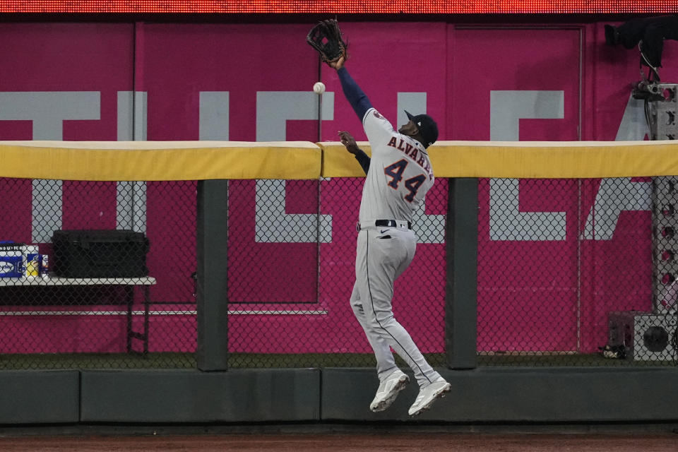 Houston Astros designated hitter Yordan Alvarez can't get a glove on a home run by Atlanta Braves' Jorge Soler during the seventh inning in Game 4 of baseball's World Series between the Houston Astros and the Atlanta Braves Saturday, Oct. 30, 2021, in Atlanta. (AP Photo/Brynn Anderson)