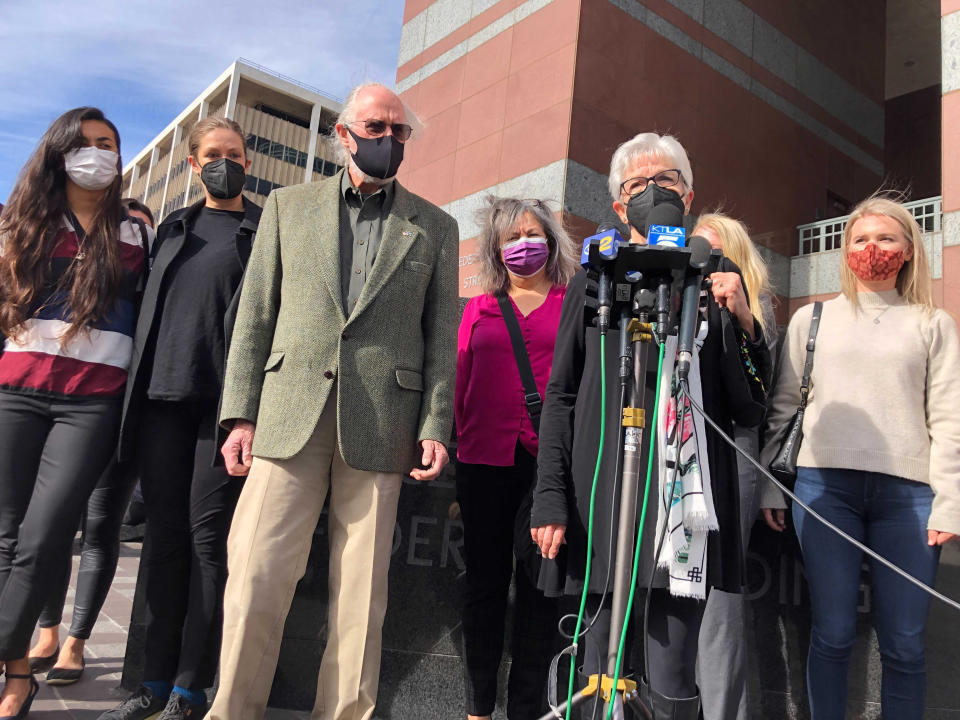 Kathleen McIlvain, center, speaks outside federal court in Los Angeles on Feb. 16, 2021, after the court appearance of Jerry Boylan, a scuba dive boat captain who is charged with 34 counts of seaman's manslaughter. McIlvain's son, Charles McIlvain, was among 34 people killed during a 2019 fire aboard Boylan's boat. (AP Photo/Stefanie Dazio)