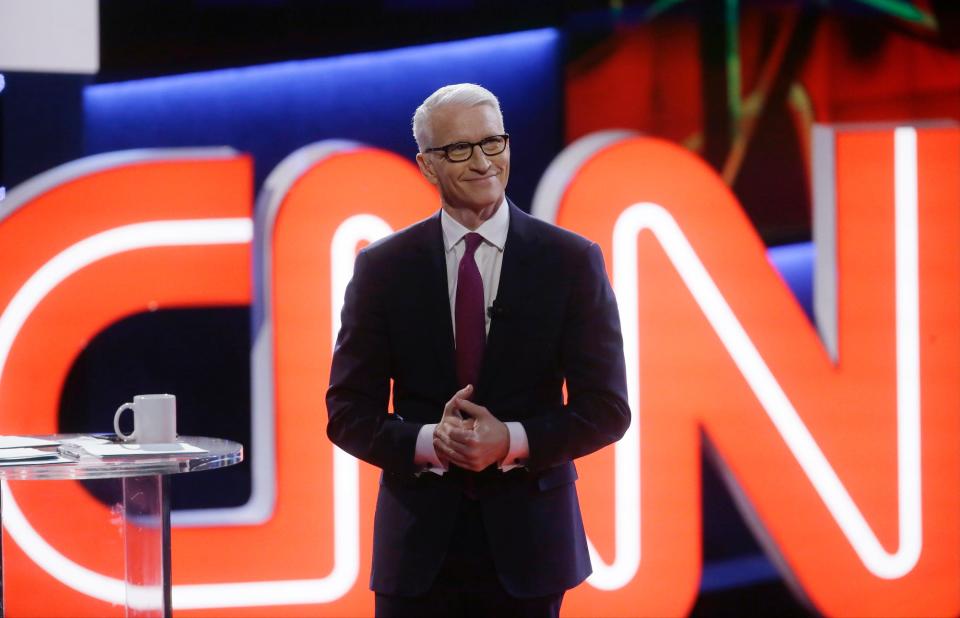 Moderator Anderson Cooper, of CNN, looks on before a Democratic presidential primary debate at the University of Michigan-Flint, Sunday, March 6, 2016, in Flint, Mich.