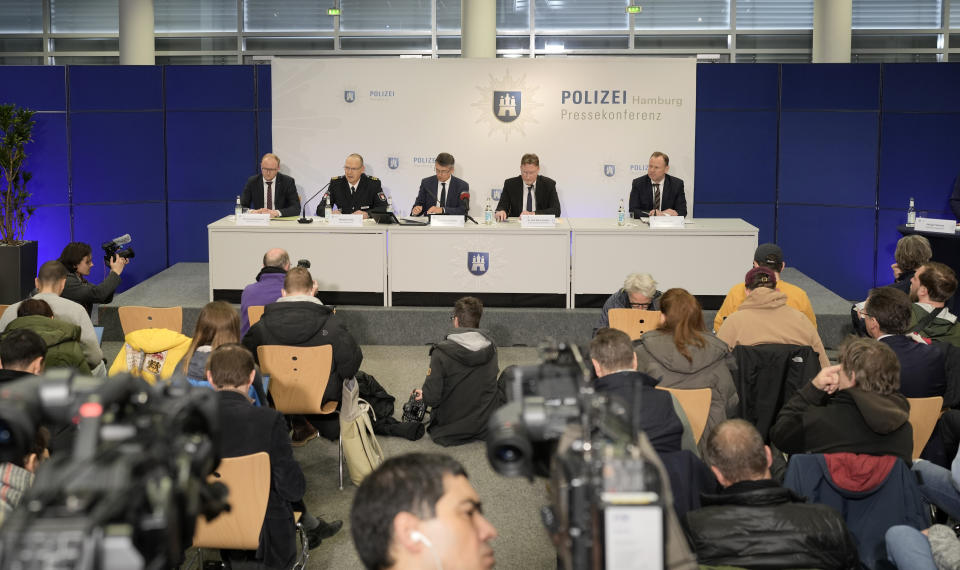 Police and prosecutors talk to the media at a press conference after the shooting at a Jehovah's Witness building in Hamburg, Germany Friday, March 10, 2023. Shots were fired inside the building used by Jehovah's Witnesses in the northern German city of Hamburg on Thursday evening, with multiple people killed and wounded, police said. (AP Photo/Markus Schreiber)