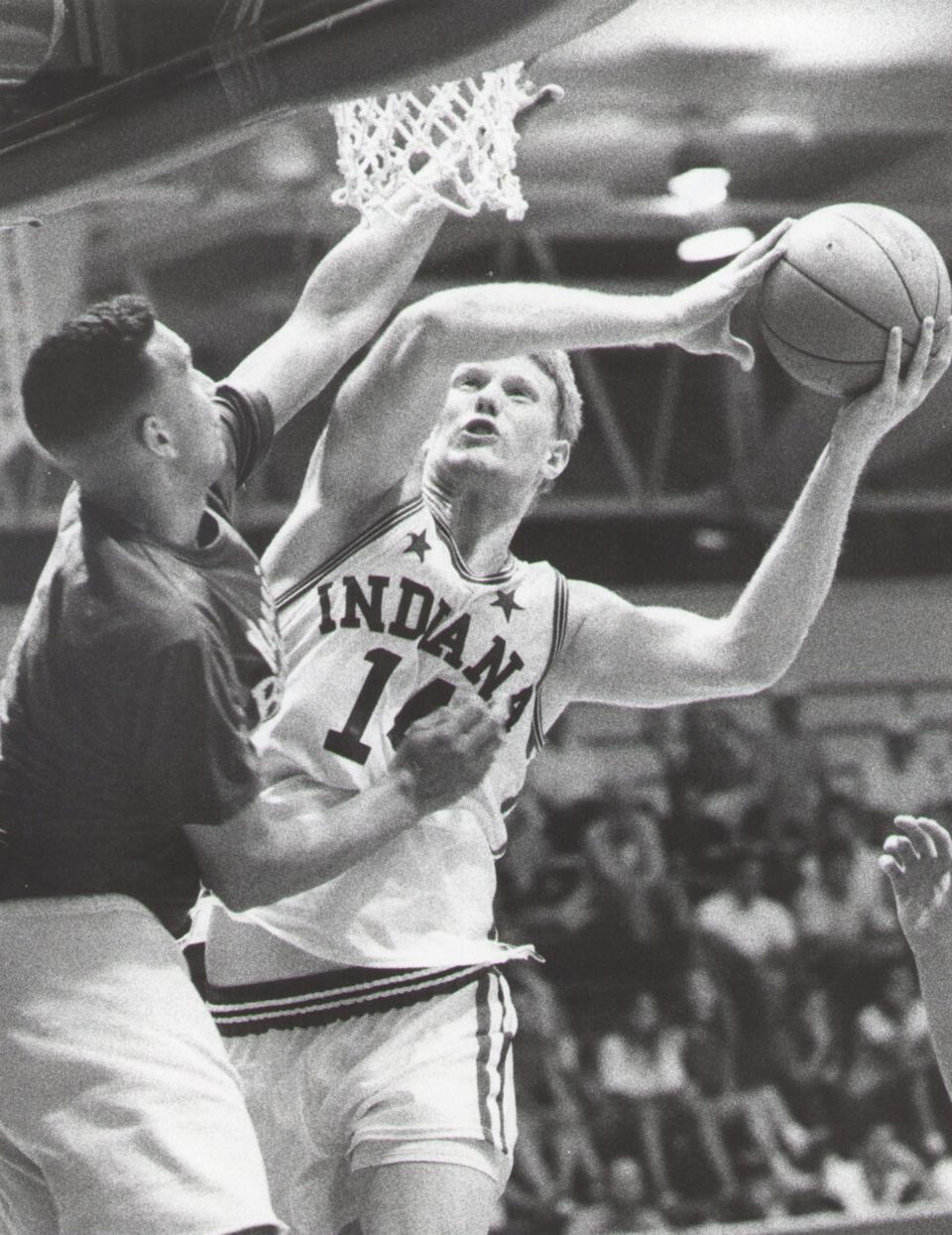 Indiana All-Star Chris Lawson shoots over ex-Notre Dame star Ken Barlow in an exhibition game pitting the Indiana All-Stars against former Indiana basketball stars.  1989