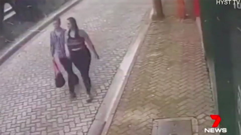 A couple is walking along an unidentified street when the unexpected happens. Source: 7 News