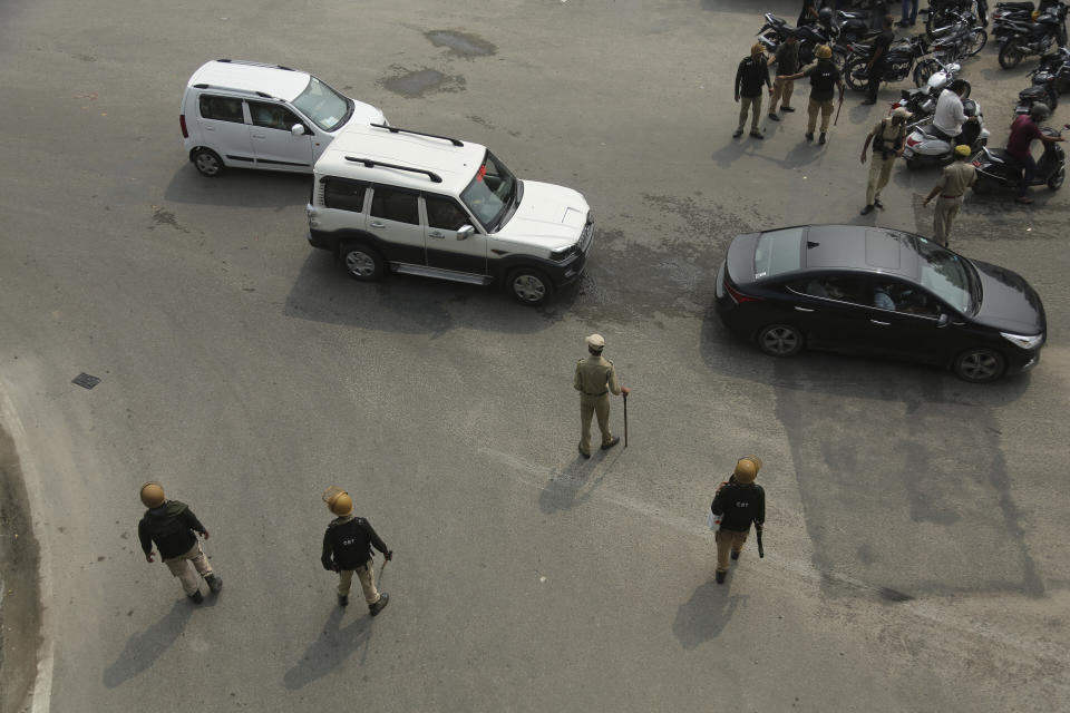 Indian police check identity of commuters and restrict traffic in Jammu, India, Tuesday, Aug.6, 2019. India's lower house of Parliament was set to ratify a bill Tuesday that would downgrade the governance of India-administered, Muslim-majority Kashmir amid an indefinite security lockdown in the disputed Himalayan region. The Hindu nationalist-led government of Prime Minister Narendra Modi moved the "Jammu and Kashmir Reorganization Bill" for a vote by the Lok Sahba a day after the measure was introduced alongside a presidential order dissolving a constitutional provision that gave Kashmiris exclusive, hereditary rights. (AP Photo/Channi Anand)