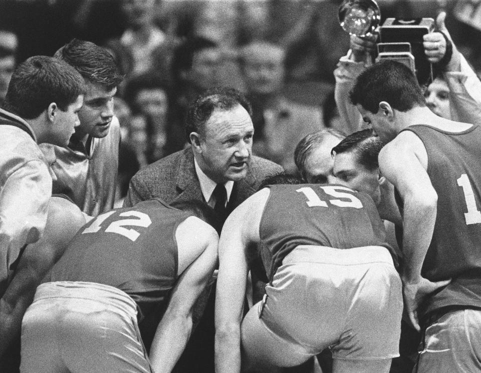 FILE - Actor Gene Hackman plays coach Norman Dale during filming of the final game in the movie "Hoosiers" at Hinkle Fieldhouse on the Butler University campus, Friday, Dec. 6, 1985, in Indianapolis. The movie — ranked as the No. 1 sports film of all-time by The Associated Press in 2020 — was released in 1986. (AP Photo/Tom Strickland, File)