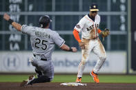 Houston Astros shortstop Jeremy Pena, right, forces out Chicago White Sox's Andrew Vaughn at second base on a ball hit by Eloy Jimenez, ending the top of the fifth inning of a baseball game, Thursday, March 30, 2023, in Houston. (AP Photo/Kevin M. Cox)