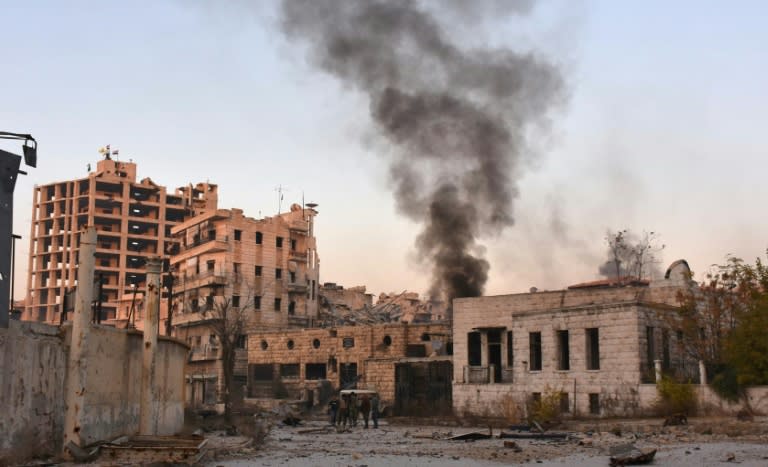 Smoke billows in Aleppo's Bustan al-Basha neighbourhood on November 28, 2016, during Syrian pro-government forces assault to retake the entire northern city from rebel fighters