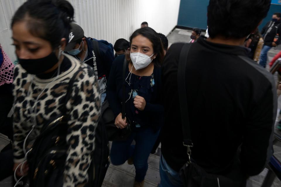 Commuters wearing facemasks walk at a metro station in Mexico City, on December 4, 2020 amid the COVID-19 coronavirus pandemic. (Photo by ALFREDO ESTRELLA / AFP) (Photo by ALFREDO ESTRELLA/AFP via Getty Images)