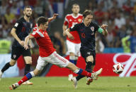 <p>Daler Kuziaev and Croatia’s Luka Modric challenge for the ball in Sochi </p>