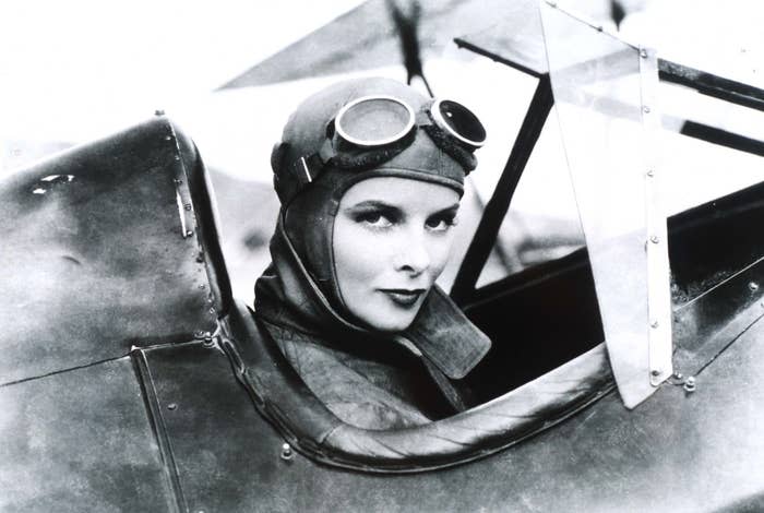 Katharine Hepburn wearing flying goggles taking a portrait for a film