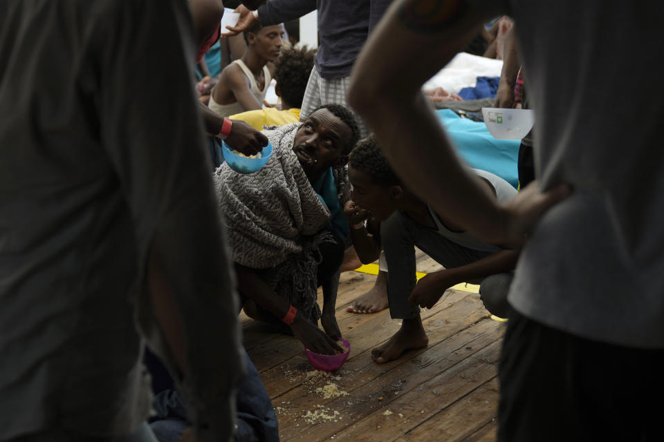 FILE - A migrant eats on the deck of the Spanish NGO Open Arms lifeguard ship after being rescued from open waters during a rescue operation in an international waters zone of the Mediterranean sea, Sept. 21, 2022. The back-to-back shipwrecks of migrant boats off Greece that left at least 22 people dead this week has once again put the spotlight on the dangers of the Mediterranean migration route to Europe. (AP Photo/Petros Karadjias file)