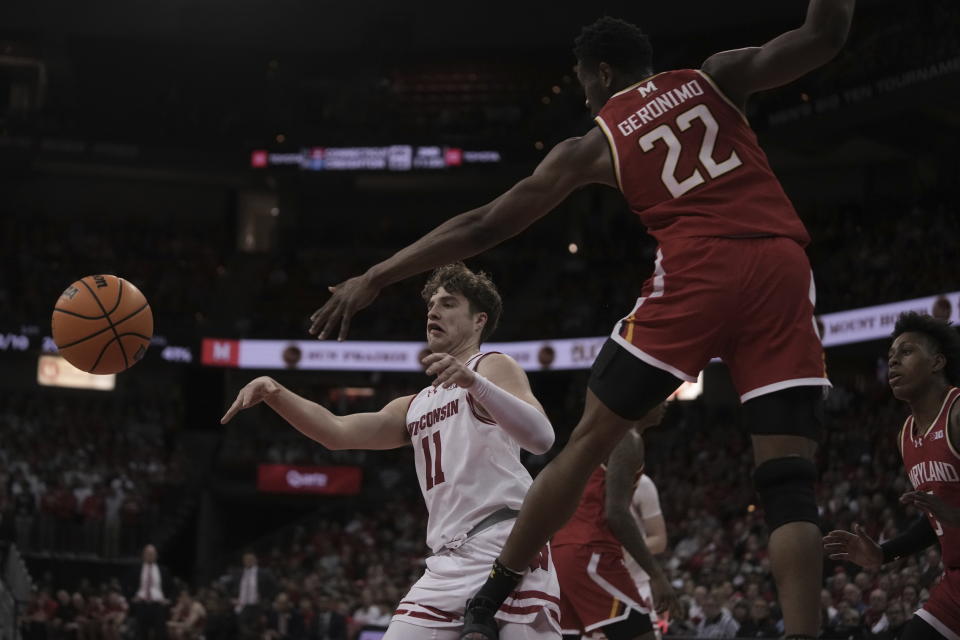 Wisconsin's Max Klesmit passes past Maryland's Jordan Geronimo during the second half of an NCAA college basketball game Tuesday, Feb. 20, 2024, in Madison, Wis. (AP Photo/Morry Gash)