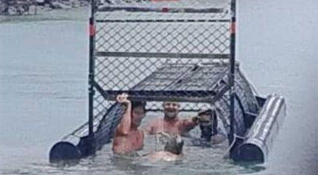 Four men photographed inside a croc trap in Cairns. Source: 7 News