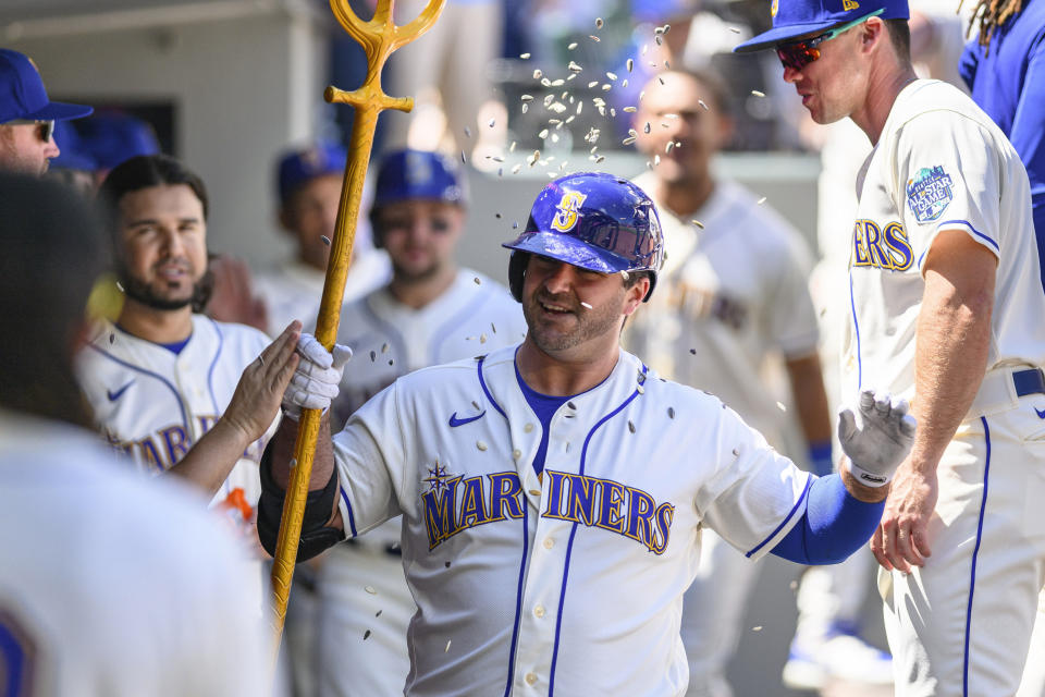 Seattle Mariners' Mike Ford celebrates his two-run home run in the dugout during the second inning of a baseball game against the Toronto Blue Jays, Sunday, July 23, 2023, in Seattle. (AP Photo/Caean Couto)