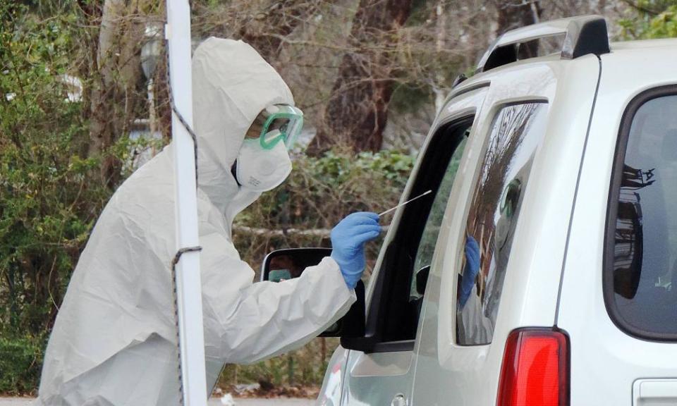 A municipal stadium parking lot in Italy which has been turned into a drive-through coronavirus testing site.