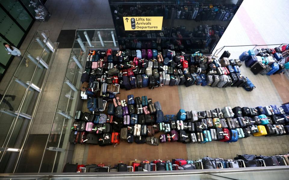 Lines of passenger luggage lying outside Heathrow Terminal 2 - HENRY NICHOLLS/REUTERS