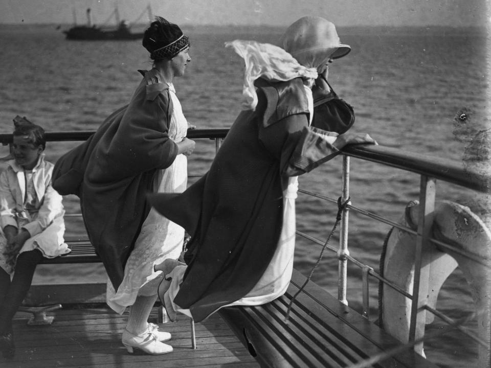 Two women enjoying the sea breeze from the deck of the Golden Eagle liner in 1923.