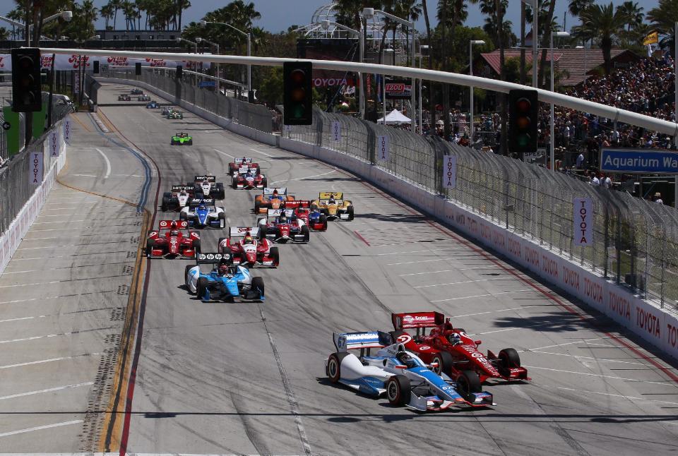 Josef Newgarden (67) attempts a pass on Dario Franchitti (10), of Scotland, heading into the first turn at the start of the IndyCar Series' Long Beach Grand Prix auto race, Sunday, April 15, 2012, in Long Beach, Calif. Newgarden hit a tire barrier, and was out of the race. (AP Photo/LAT, Michael L. Levitt)