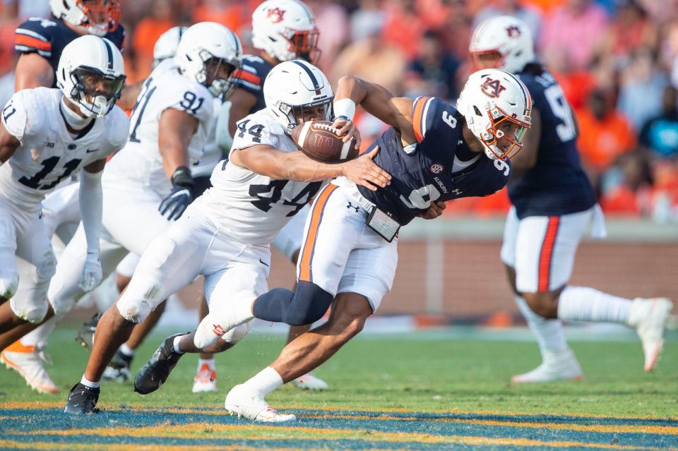 AUBURN, ALABAMA - SEPTEMBER 17: Quarterback Robby Ashford #9 of the Auburn Tigers looks to escape a tackle by defensive end Chop Robinson #44 of the Penn State Nittany Lions during the second half of play at Jordan-Hare Stadium on September 17, 2022 in Auburn, Alabama. (Photo by Michael Chang/Getty Images)