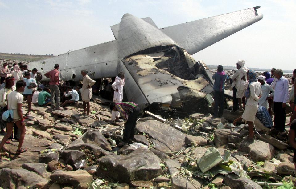 Indian villagers crowd around the debris of an Indian air force cargo plane that crashed near Karauli village in the central Indian state of Madhya Pradesh, Friday, March 28, 2014. C-130J Hercules plane inducted into service just last year crashed during a training mission Friday, killing all five crew members in the latest in a series of accidents that have hit the Indian armed forces. (AP Photo)