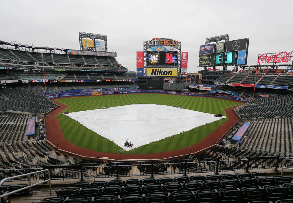 The tarp covers the infield at Citi Field in New York. The Brewers home opener in the ballpark has been pushed back to Friday.