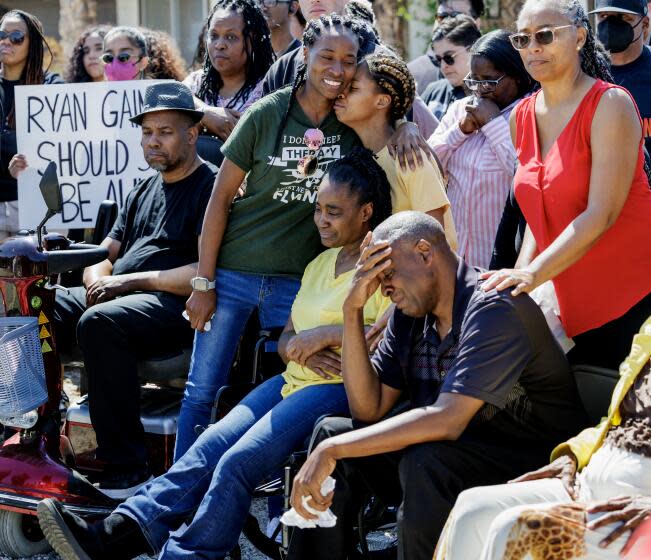 APPLE VALLEY, CA - MARCH 21, 2024: Family members of slain Ryan Gainer attend a press conference in front of their home announcing a lawsuit against the San Bernardino County Sheriff's Department on March 21, 2024 in Apple Valley, California. Ryan Gainer, a 15-year old with autism, was fatally shot by sheriffs outside his Apple Valley home earlier this month. From the left, sisters Rachel Gainer, Rebecca Gainer, mother Sharon Hayward and father Norman Gainer.(Gina Ferazzi / Los Angeles Times)