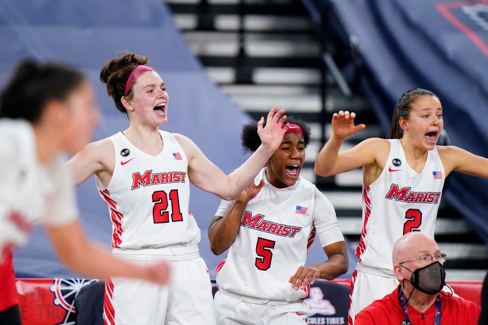 Marist's Willow Duffell (21), Trinasia Kennedy (5) and Allie Best (2) celebrate in the second half of an NCAA college basketball game against Saint Peter's during the finals of the Metro Atlantic Athletic Conference tournament, Saturday, March 13, 2021, in Atlantic City, N.J. (AP Photo/Matt Slocum)